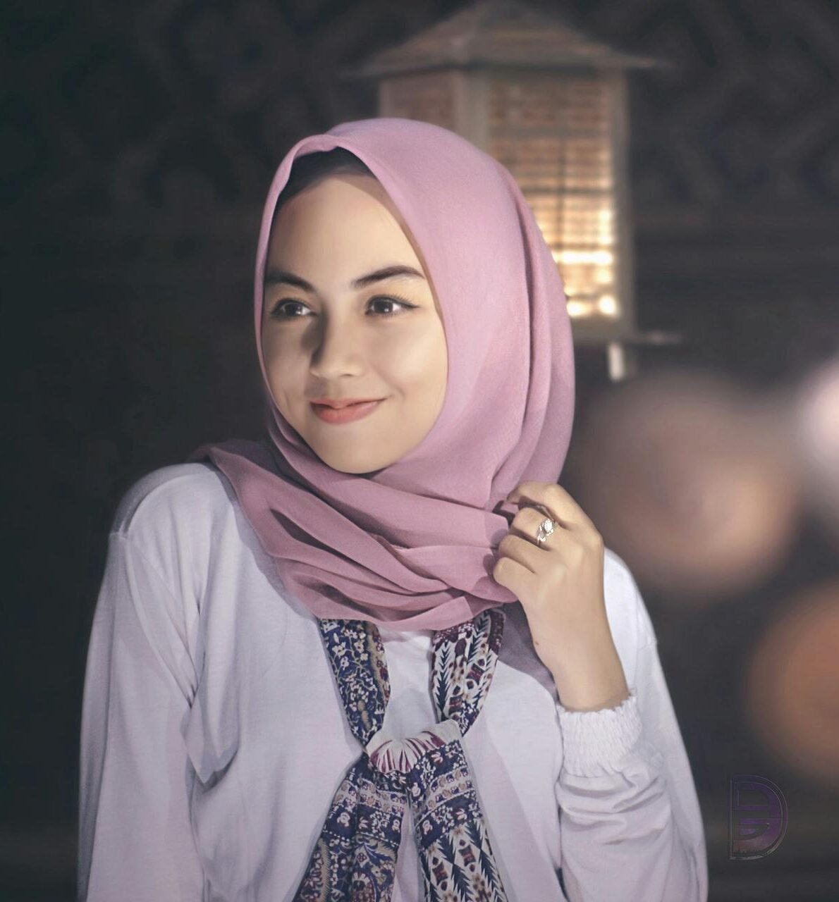 A serene portrait of a woman wearing a pink hijab, exuding grace and elegance.